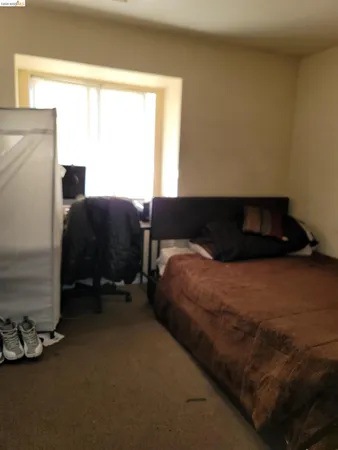 a bedroom with a bed and a chair