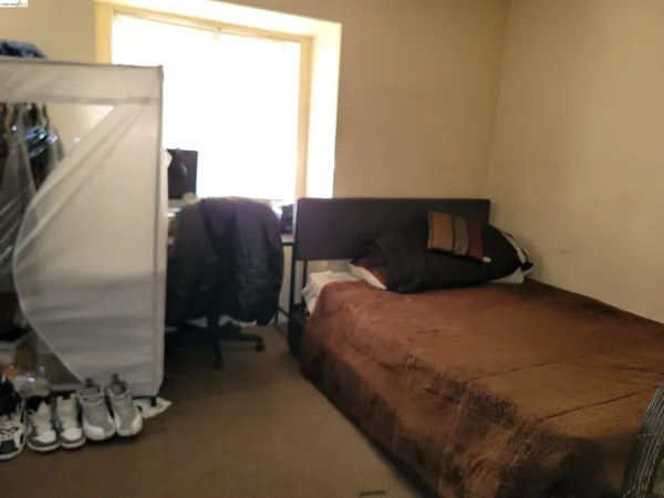 a bed room with a bed and a chair