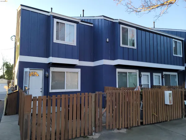 a front view of a house with a fence