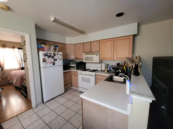 a kitchen with sink a refrigerator and cabinets