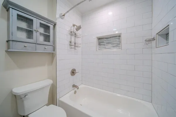 a bathroom with a toilet and shower