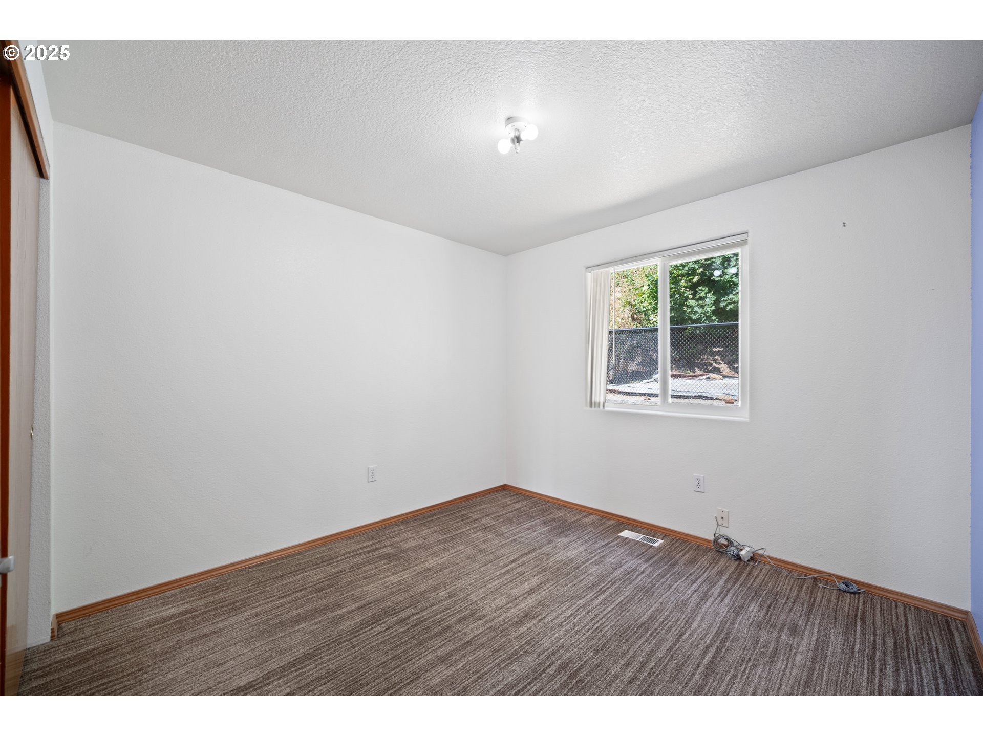 2229 Northwest 6th Place Camas, WA 98607 - Photo 11 of 31 a view of an empty room with wooden floor and a window