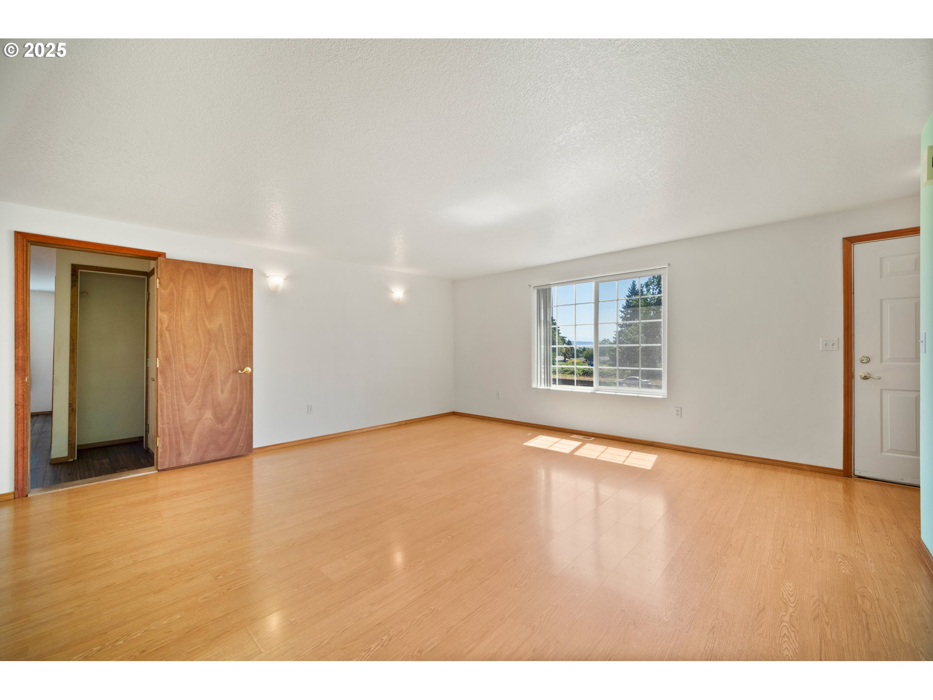 2229 Northwest 6th Place Camas, WA 98607 - Photo 16 of 31 a view of an empty room with a window and wooden floor