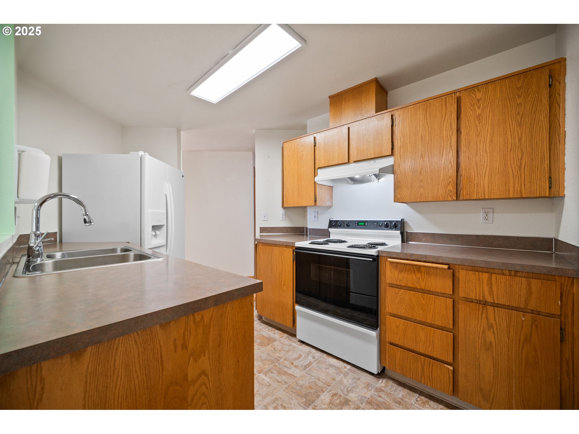 2229 Northwest 6th Place Camas, WA 98607 - Photo 19 of 31 a kitchen with granite countertop a sink stove and refrigerator