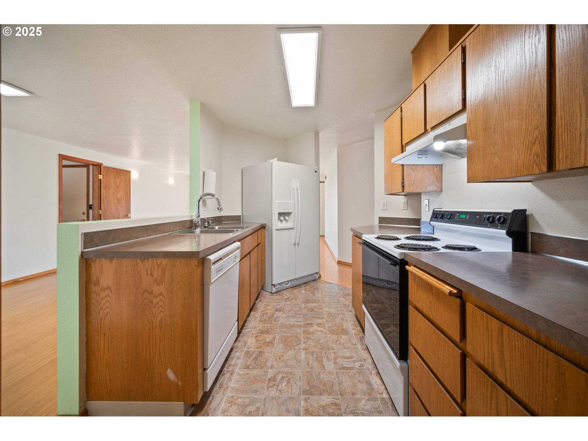 2229 Northwest 6th Place Camas, WA 98607 - Photo 20 of 31 a kitchen with stainless steel appliances granite countertop a sink stove and refrigerator