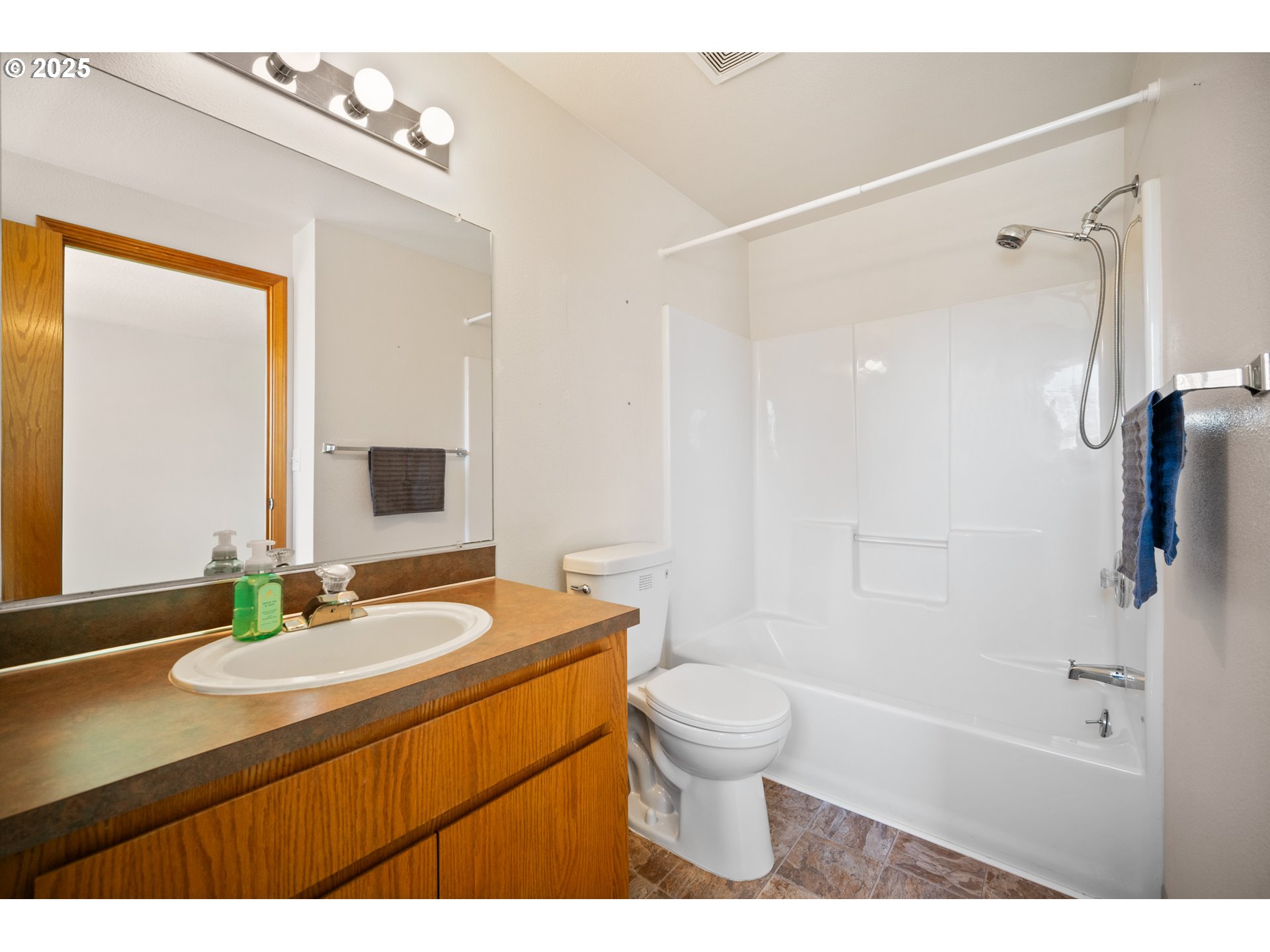 2229 Northwest 6th Place Camas, WA 98607 - Photo 9 of 31 a bathroom with a sink a toilet a mirror and shower