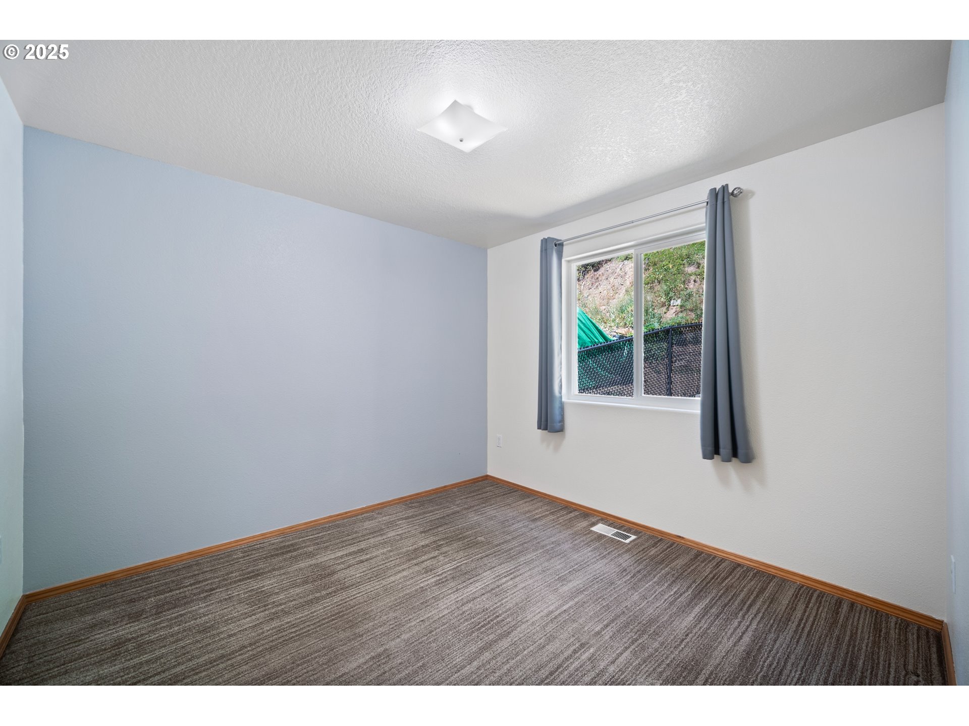 2229 Northwest 6th Place Camas, WA 98607 - Photo 10 of 31 a view of an empty room with wooden floor and window