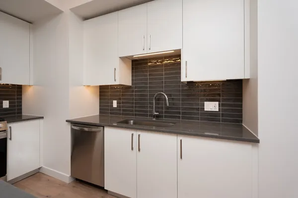 a kitchen with wooden cabinets and stainless steel appliances