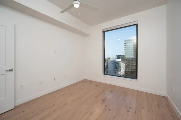 a bathroom with a granite countertop sink and a large mirror