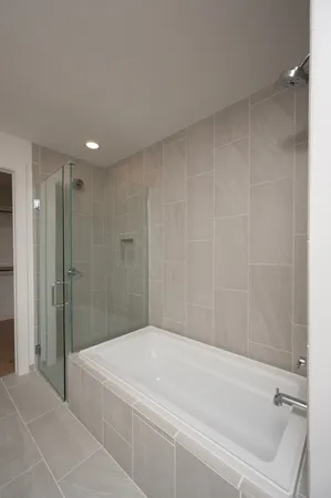 a bathroom with a shower and a tub