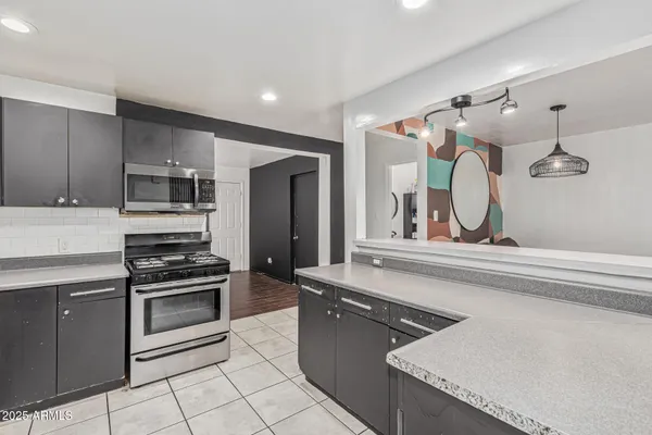 a kitchen with a stove a sink and a refrigerator