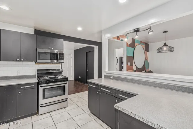 a kitchen with a stove a sink and a refrigerator