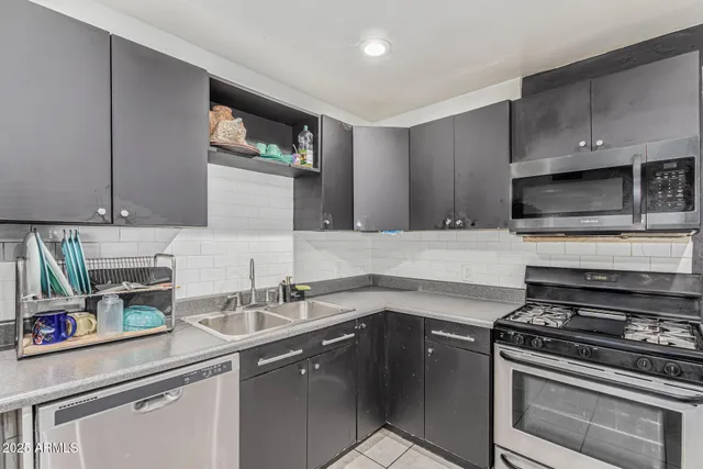a kitchen with a sink stove and cabinets