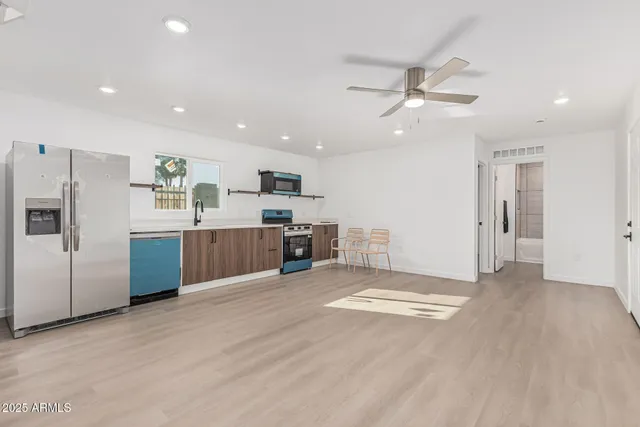a view of kitchen with refrigerator and microwave