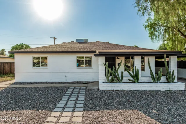a front view of a house with a garden