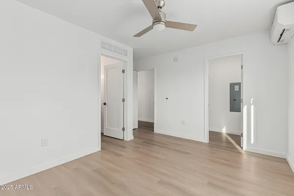 a view of an empty room with wooden floor