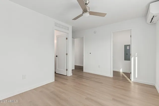 a view of an empty room with wooden floor