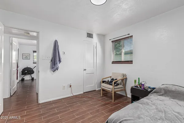 a bedroom with bed and a window