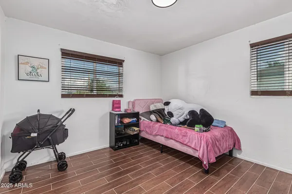 a bedroom with a bed and a chair