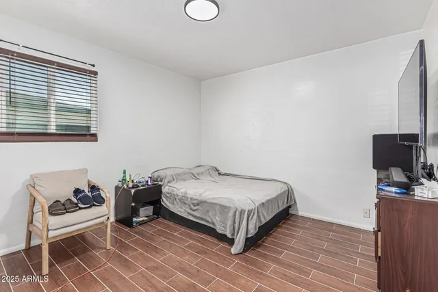 a bedroom with a bed and flat screen tv