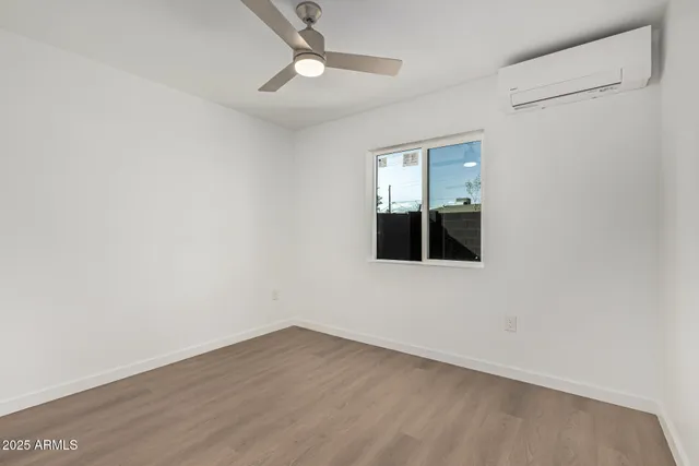 a view of a room with wooden floor