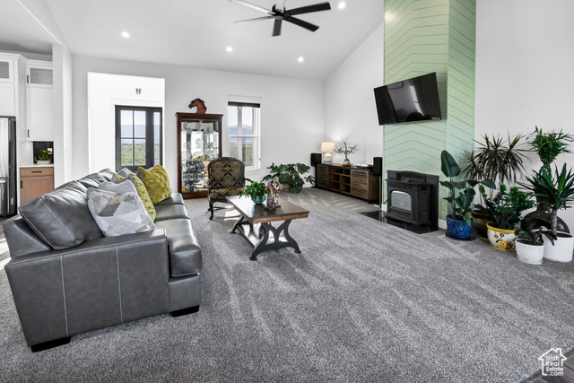 1952 Highway 118 Monroe, UT 84754 - Photo 21 of 88 Living room with a wood stove, a ceiling fan, recessed lighting, carpet flooring, and lofted ceiling
