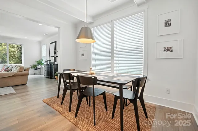 a view of a dining room with furniture and a window