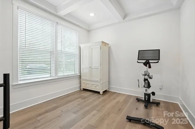 a view of a livingroom with wooden floor and a window