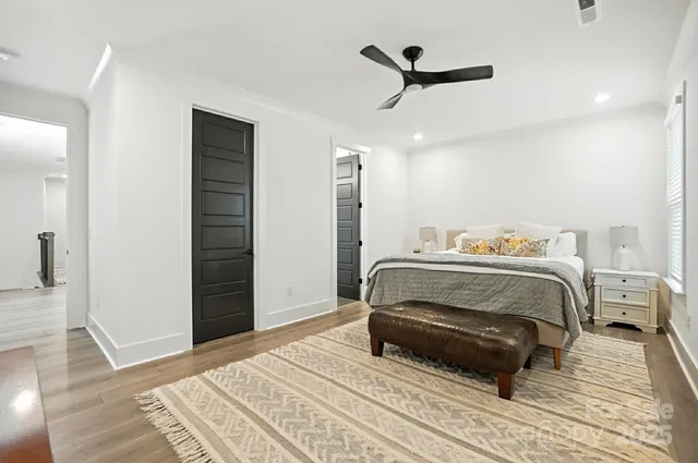 a bedroom with a bed and wooden floor