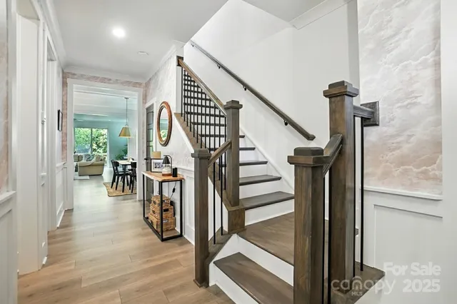 a view of entryway and hall with wooden floor