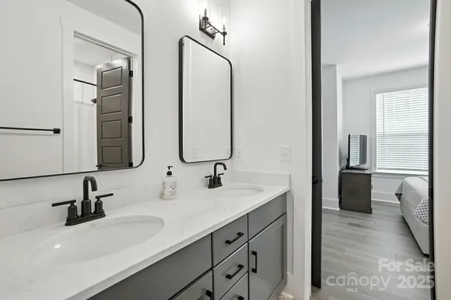 a bathroom with double vanity sinks and a mirror