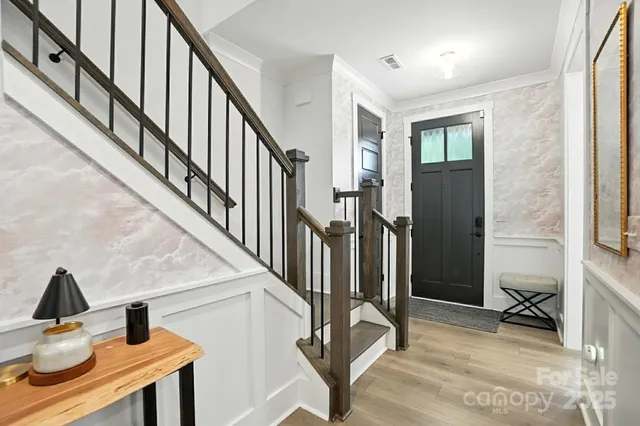 a view of entryway and hall with wooden floor
