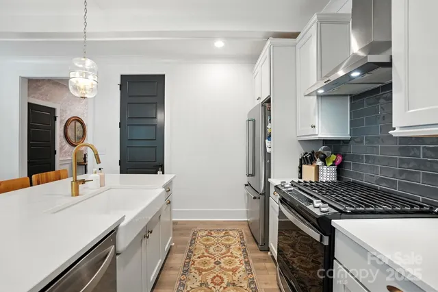 a kitchen with a sink and a stove top oven