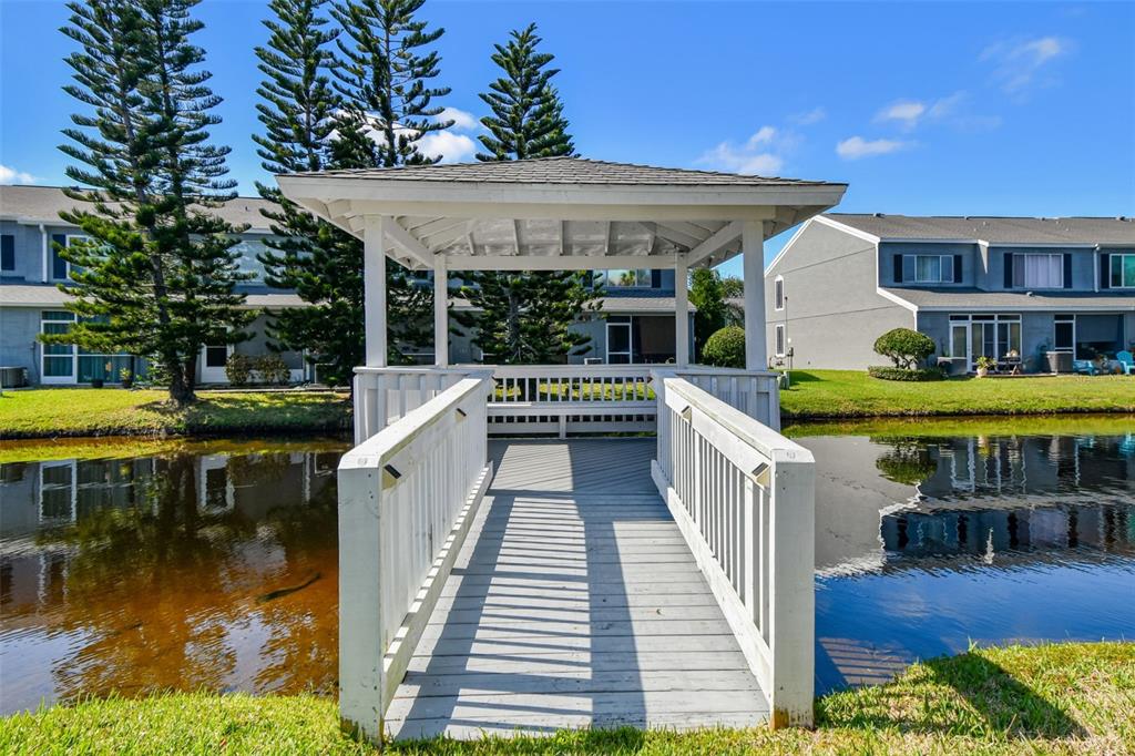 382 Countryside Key Boulevard Oldsmar, FL 34677 - Photo 56 of 58 a view of a patio with chairs next to a yard