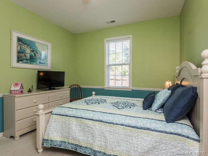 8 Morning Mist Road Fletcher, NC 28732 - Photo 12 of 24 a bedroom with a bed and flat screen tv