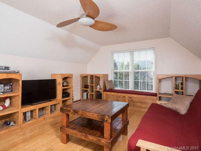 8 Morning Mist Road Fletcher, NC 28732 - Photo 16 of 24 a living room with furniture a flat screen tv and a large window