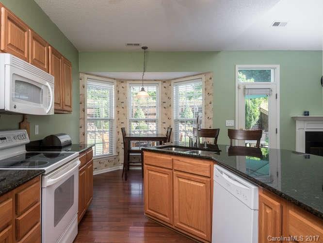 8 Morning Mist Road Fletcher, NC 28732 - Photo 7 of 24 a kitchen with granite countertop stainless steel appliances a stove sink and cabinets