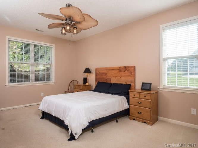 8 Morning Mist Road Fletcher, NC 28732 - Photo 9 of 24 a bedroom with a bed and a chandelier