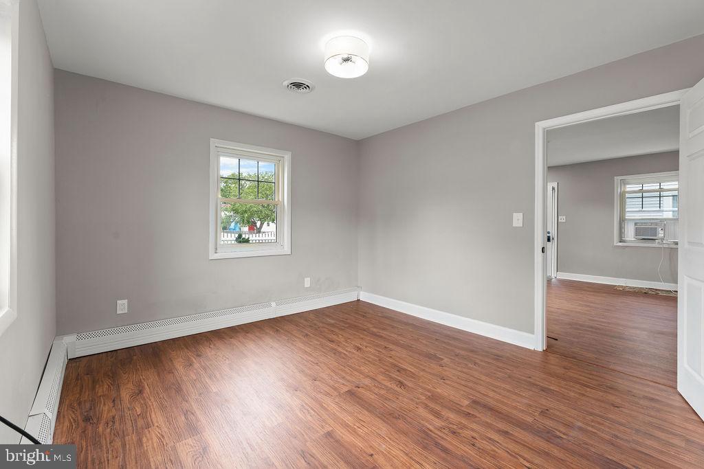 38 4th Street Laurel, MD 20707 - Photo 13 of 27 an empty room with wooden floor and windows