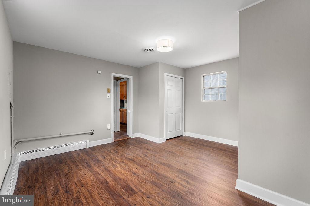 38 4th Street Laurel, MD 20707 - Photo 15 of 27 an empty room with wooden floor and windows