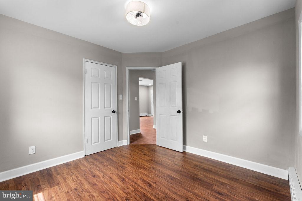 38 4th Street Laurel, MD 20707 - Photo 18 of 27 an empty room with wooden floor and windows