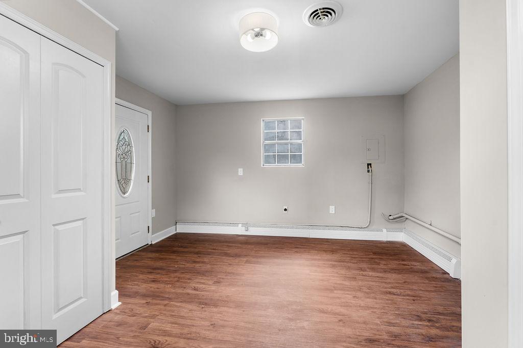 38 4th Street Laurel, MD 20707 - Photo 6 of 27 an empty room with wooden floor and windows
