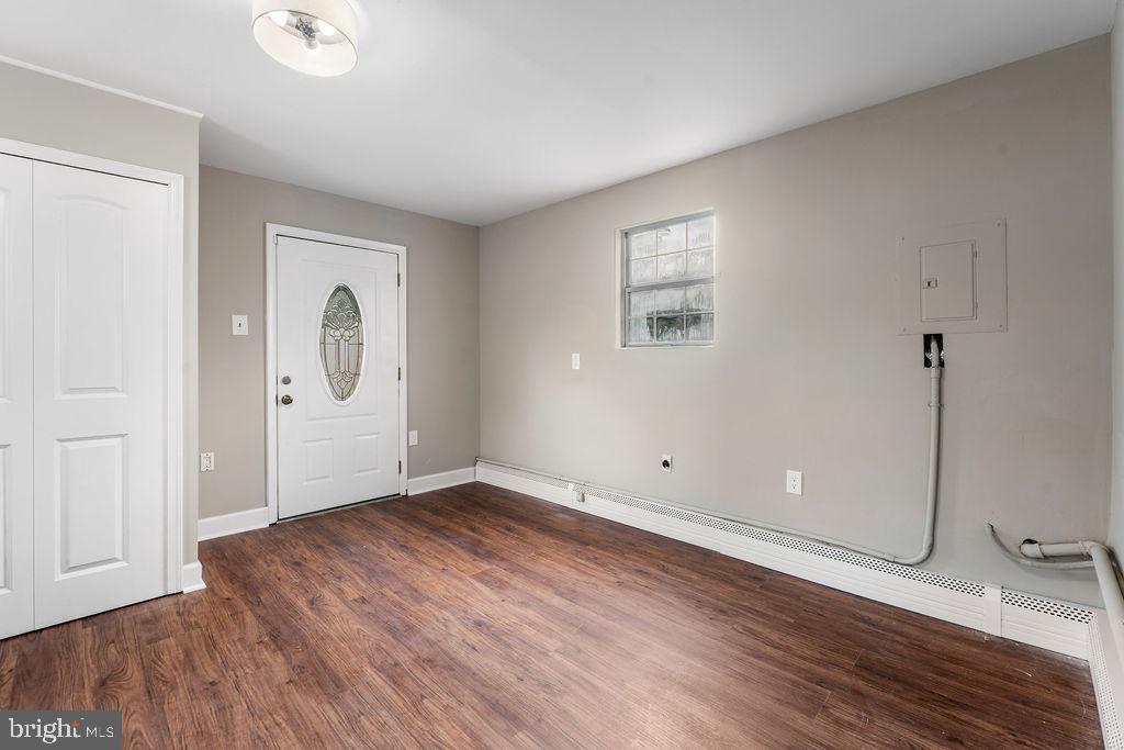 38 4th Street Laurel, MD 20707 - Photo 7 of 27 an empty room with wooden floor and windows