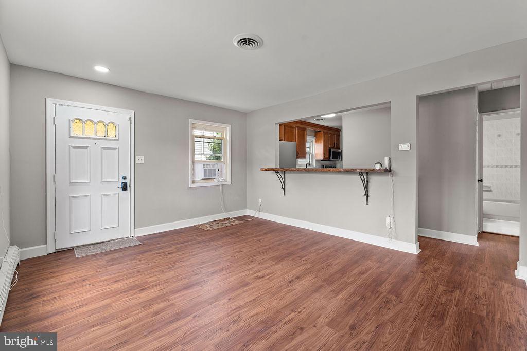 38 4th Street Laurel, MD 20707 - Photo 10 of 27 an empty room with wooden floor and a window