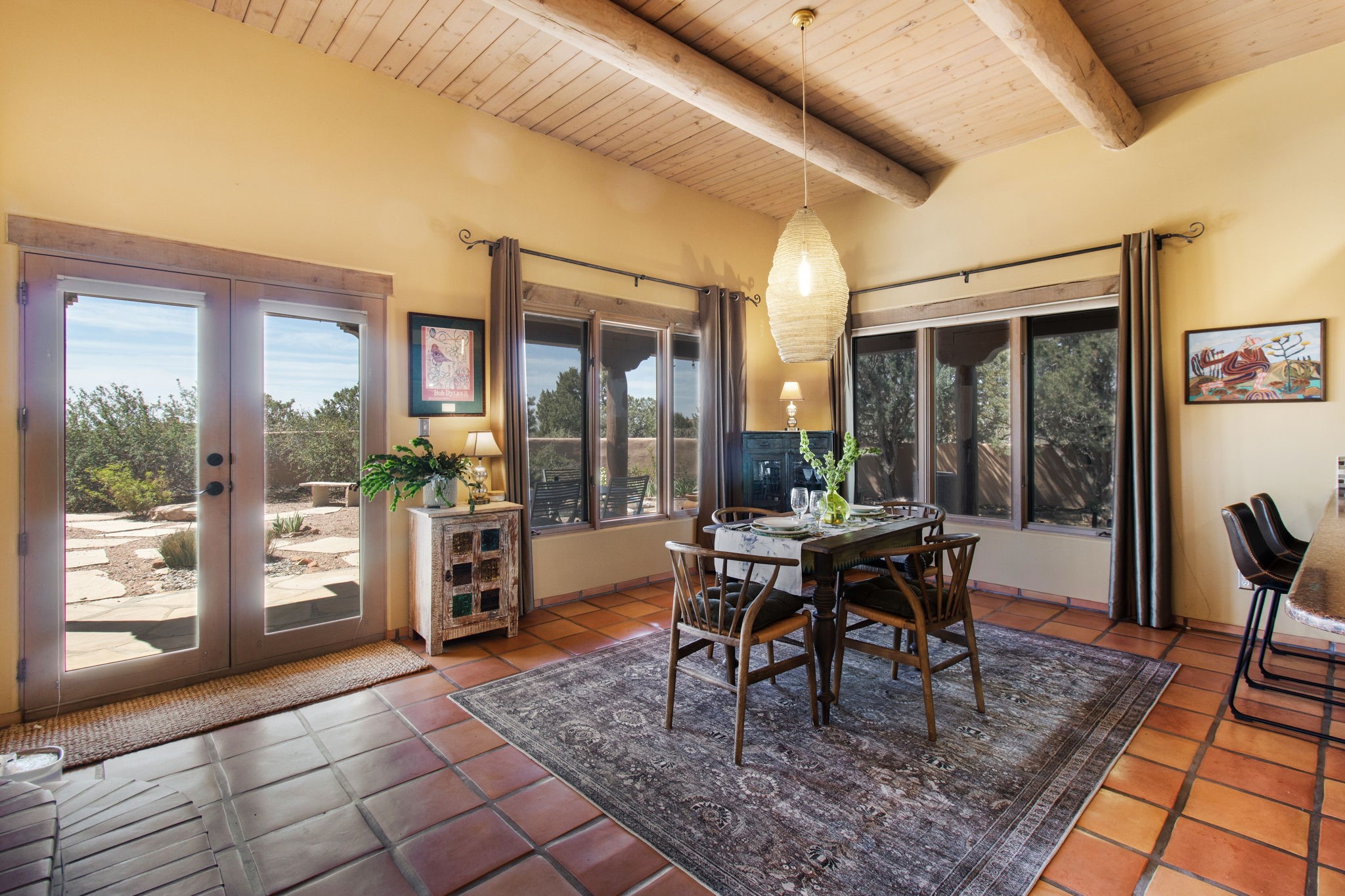 23 Monterey Road Santa Fe, NM 87508 - Photo 14 of 41 Dining room with saltillo tile, vigas and french doors to rear portal
