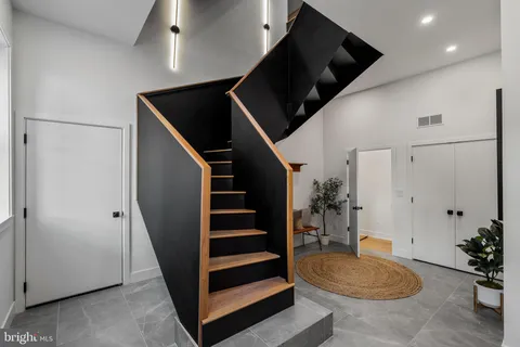 a view of entryway with wooden floor and stairs