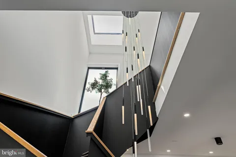 a bathroom with a sink and mirror with bathtub