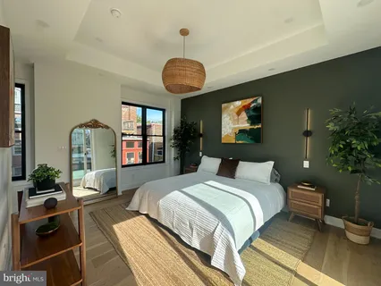 a spacious bedroom with a bed and a mirror in it