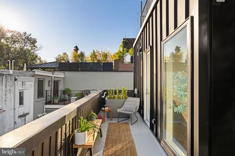 a view of a hallway with painting on the wall