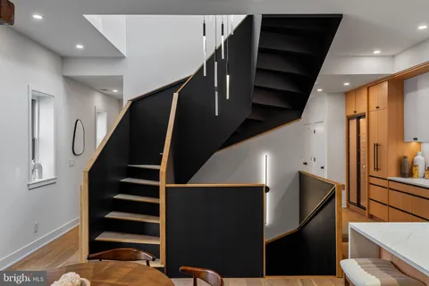 a hallway with chairs and a large window with wooden floor